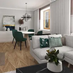 Jasnoszara kanapa z zielonymi poduszkami, okrągły stół z krzesłami w tym samym kolorze, drewniana podłoga w jodełkę i ściany w kolorze popielatym tworzą przytulne wnętrze.