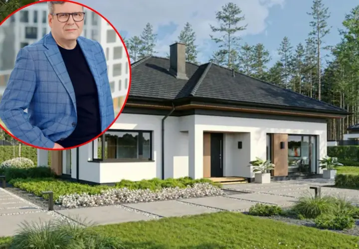 Mężczyzna w garniturze obok nowoczesnego domu. Dowiedz się, jaki jest koszt budowy domu 150m2.