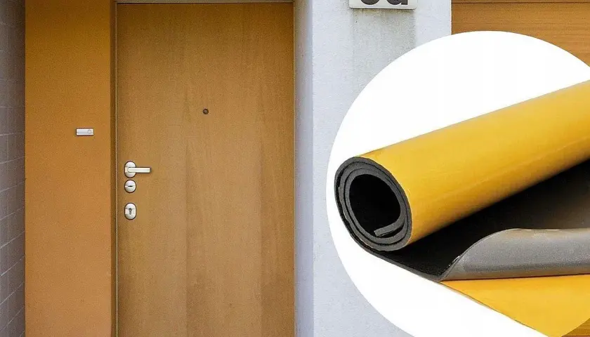 Ocieplenie drzwi wewnętrznych: rolka materiału izolacyjnego z żółtą warstwą klejącą obok drzwi wejściowych.