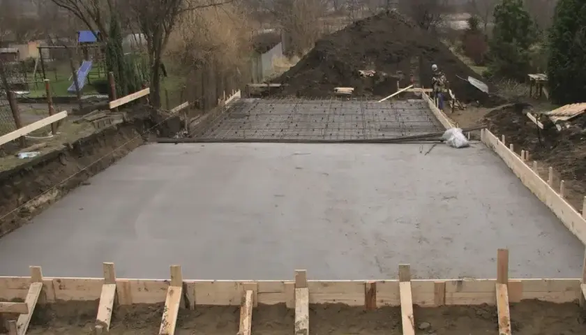 Świeżo wylany beton na fundament, zbrojenie czeka na kolejny etap budowy. Jaki beton na fundament wybrać? Ten wygląda solidnie.