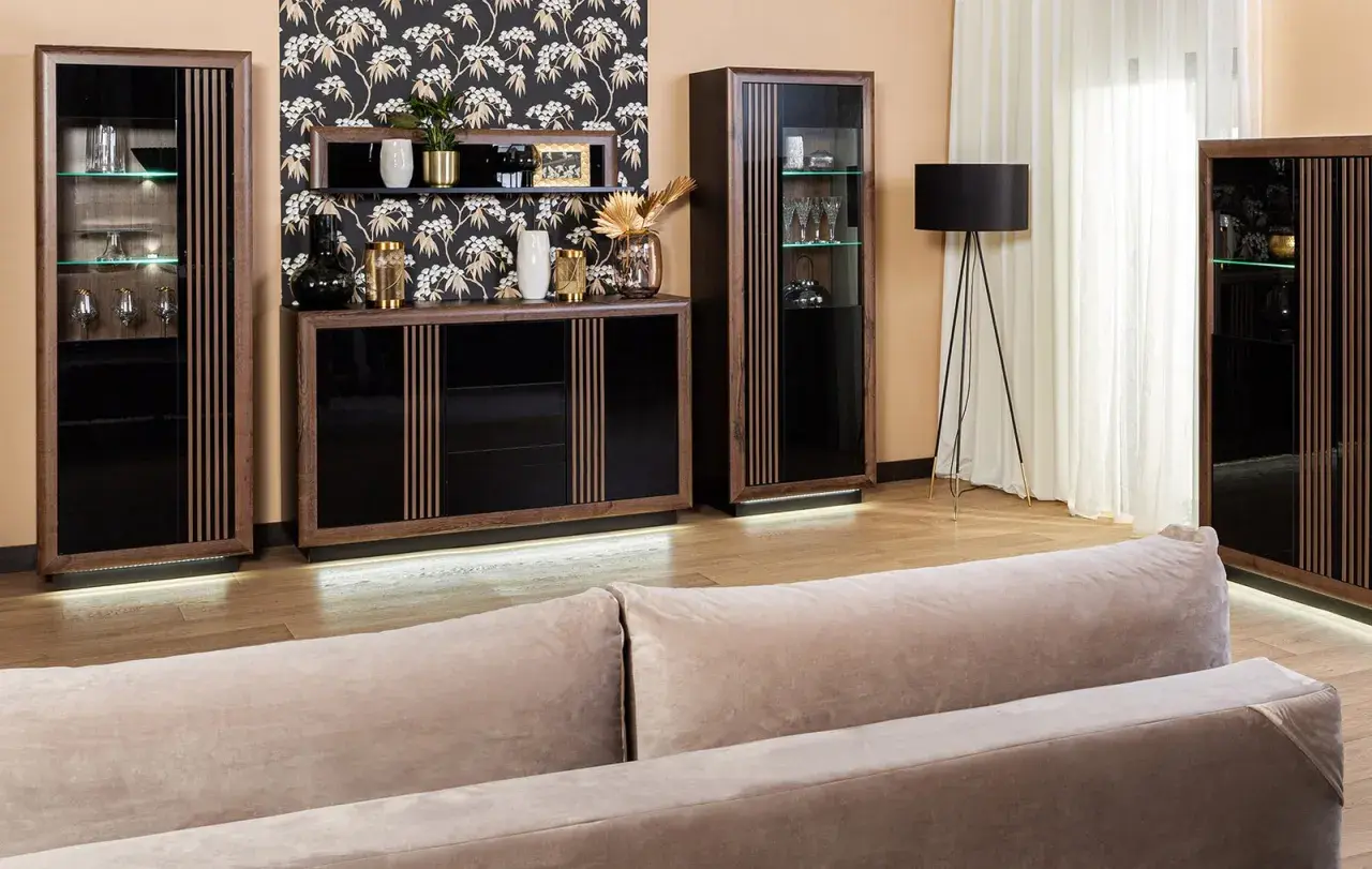 Elegancki salon z meblami z ciemnego drewna, czarnymi frontami i subtelnym oświetleniem LED.