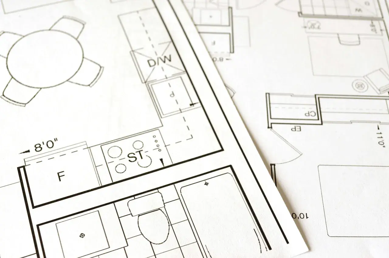 Plany architektoniczne z widocznym stołem, kuchnią (ST), łazienką (WC) i innymi pomieszczeniami. Dokumentacja do złożenia wniosku o pozwolenie na budowę.