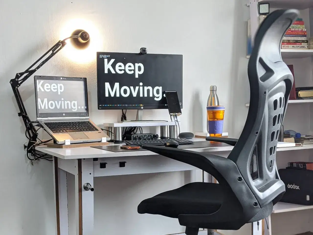 Biurko z laptopem i monitorem, oba z napisem