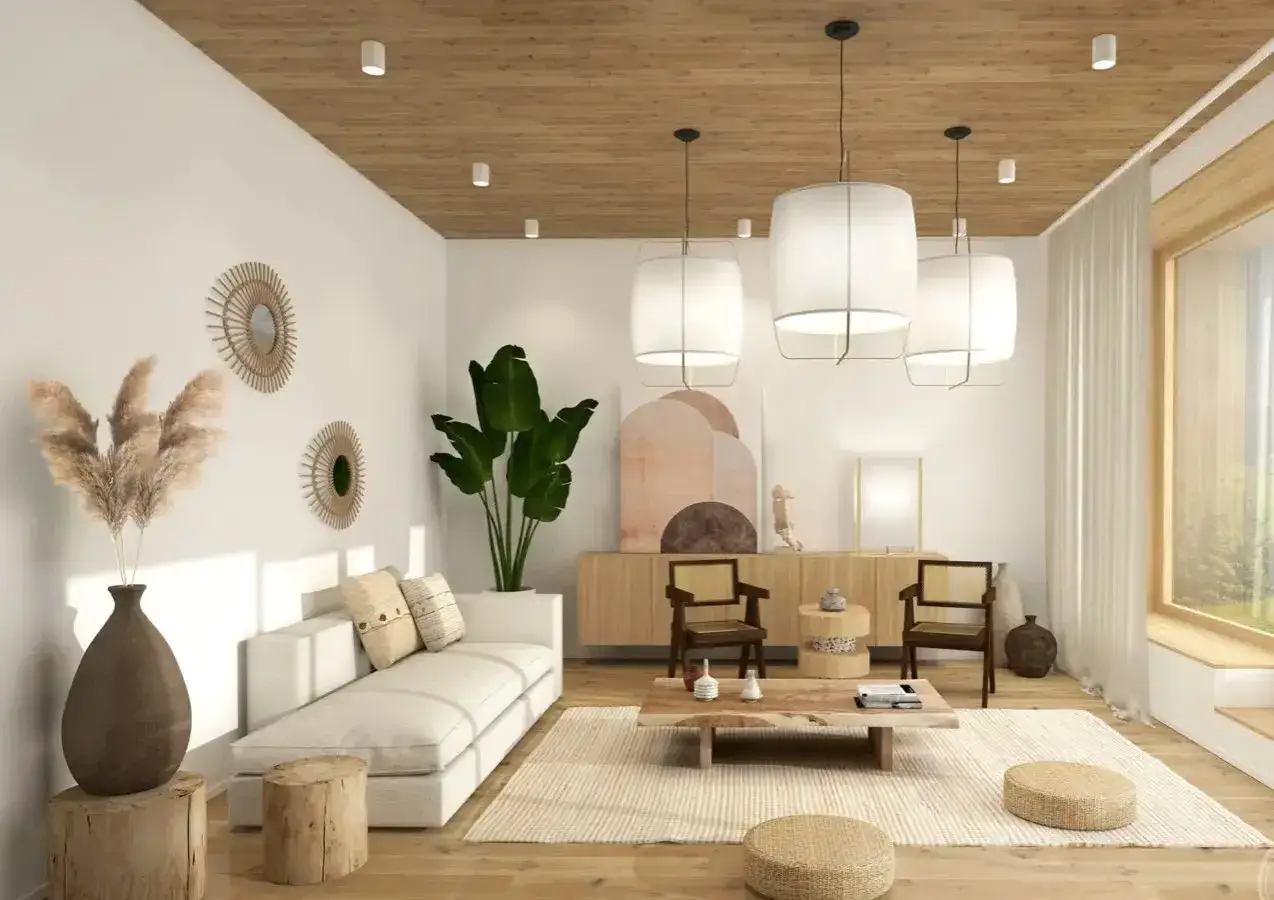 Salon w stylu japandi: biała sofa, drewniane meble, plecione dodatki i duża roślina tworzą harmonijną przestrzeń.